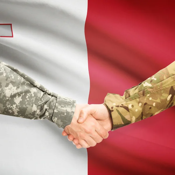 Men in uniform shaking hands with flag on background - Malta — Stock Photo, Image