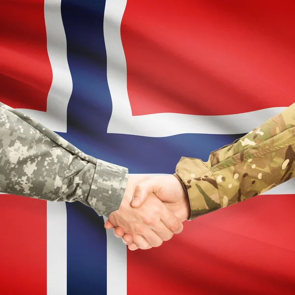 Men in uniform shaking hands with flag on background - Norway — Stock Photo, Image