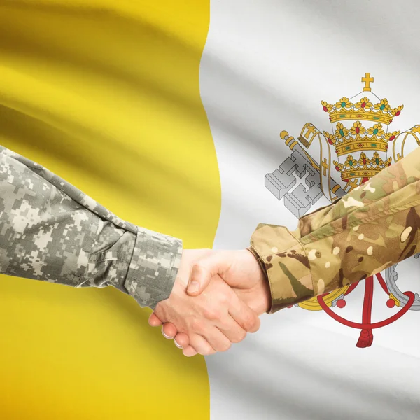 Men in uniform shaking hands with flag on background - Vatican C — Stock Photo, Image