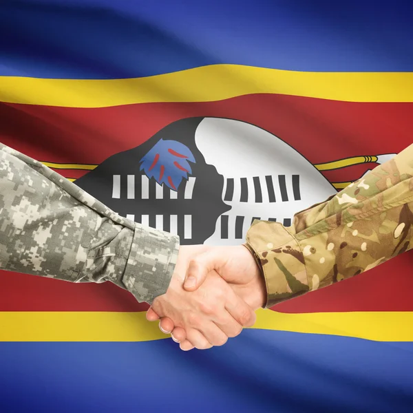 Men in uniform shaking hands with flag on background - Swaziland — Stock Photo, Image