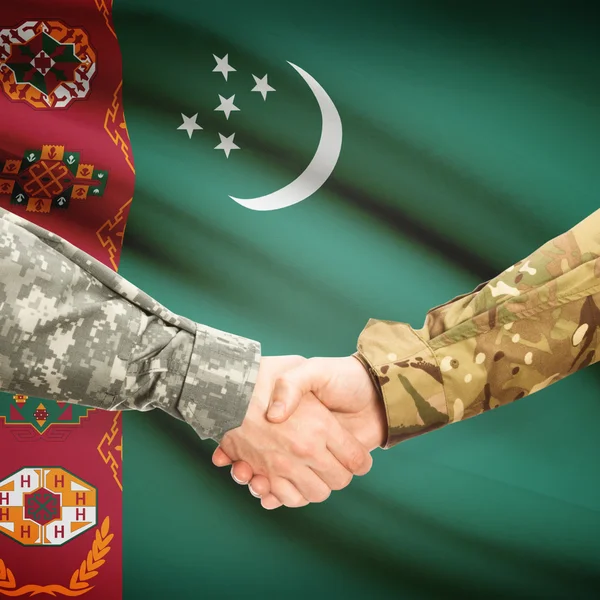 Men in uniform shaking hands with flag on background - Turkmenis — Stock Photo, Image