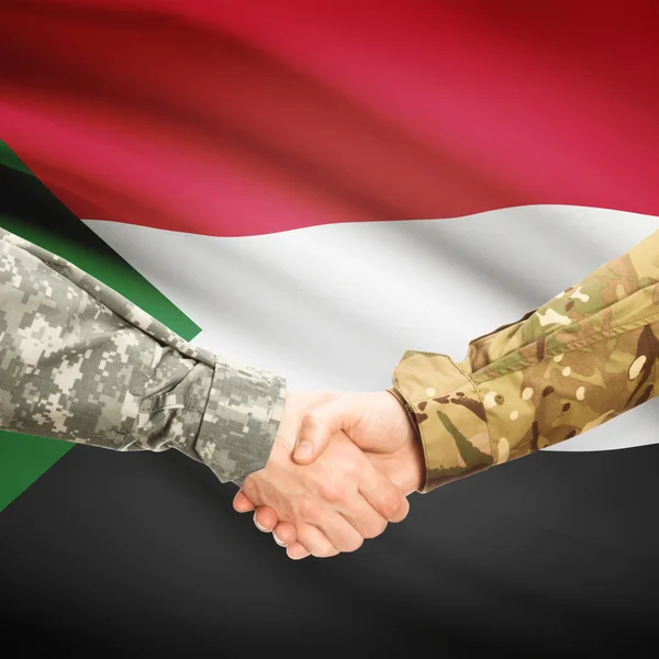 Men in uniform shaking hands with flag on background - Sudan — Stock Photo, Image