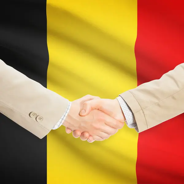 Businessmen handshake with flag on background - Belgium — Stock Photo, Image