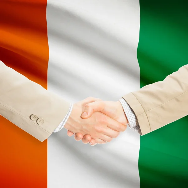 Businessmen handshake with flag on background - Ivory Coast — Stock Photo, Image