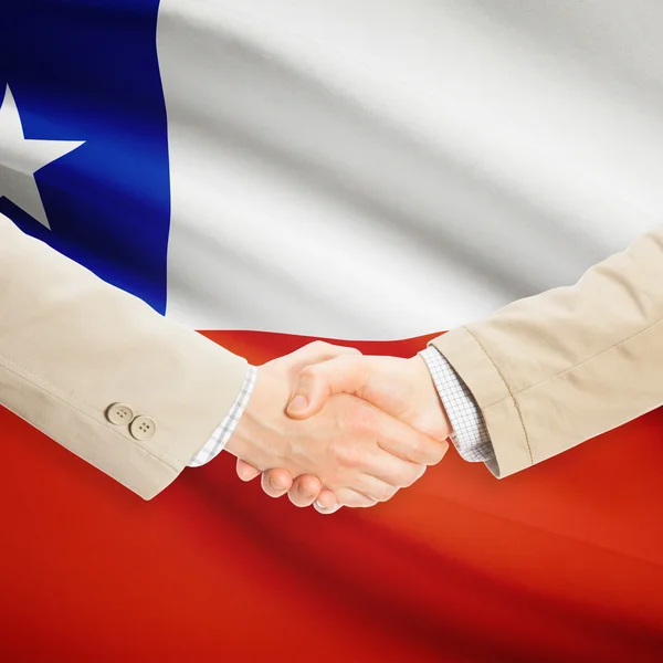 Businessmen handshake with flag on background - Chile — Stock Photo, Image