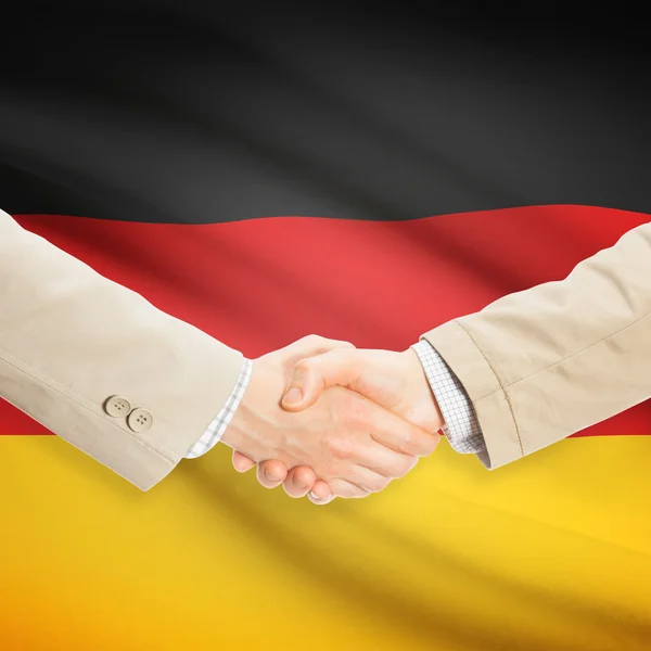 Businessmen handshake with flag on background - Germany — kuvapankkivalokuva