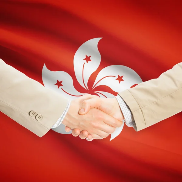 Businessmen handshake with flag on background - Hong Kong — Stock Photo, Image