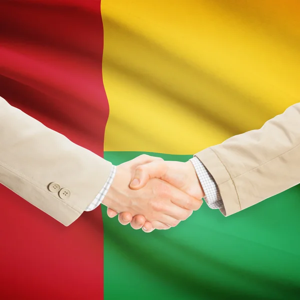 Бізнесмени рукостискання з прапором на фоні - Гвінея-Бісау — стокове фото