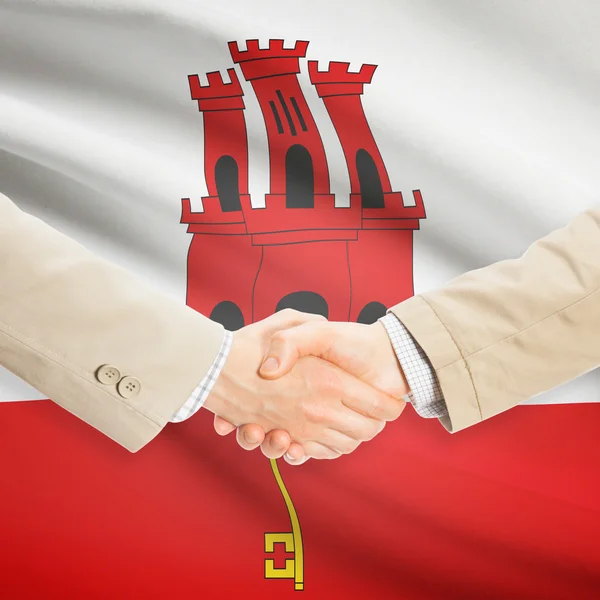 Businessmen handshake with flag on background - Gibraltar — Stock Photo, Image