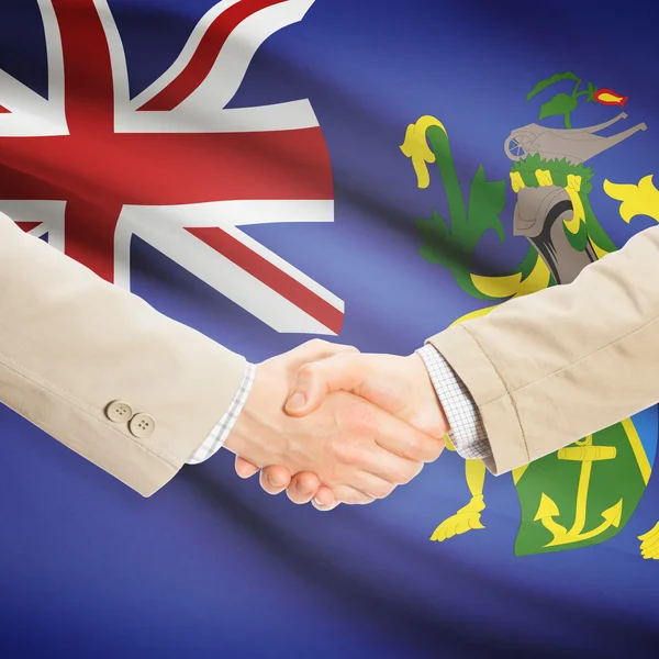Üzletemberek kézfogás zászló a háttérben - Pitcairn-szigetek — Stock Fotó