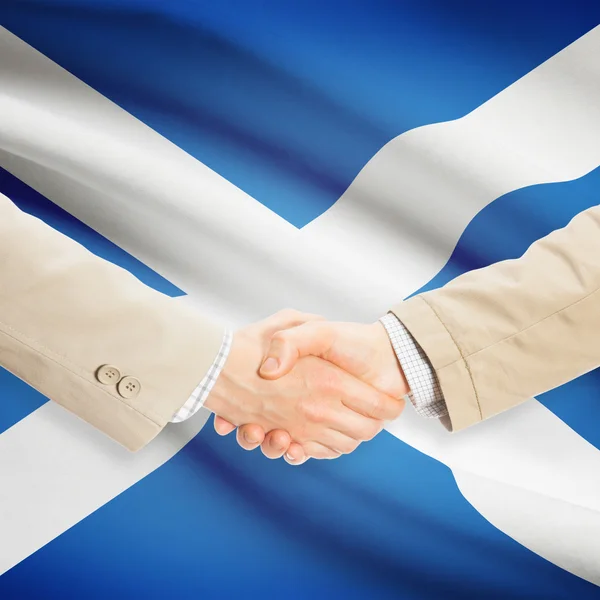 Businessmen handshake with flag on background - Scotland — Stock Photo, Image