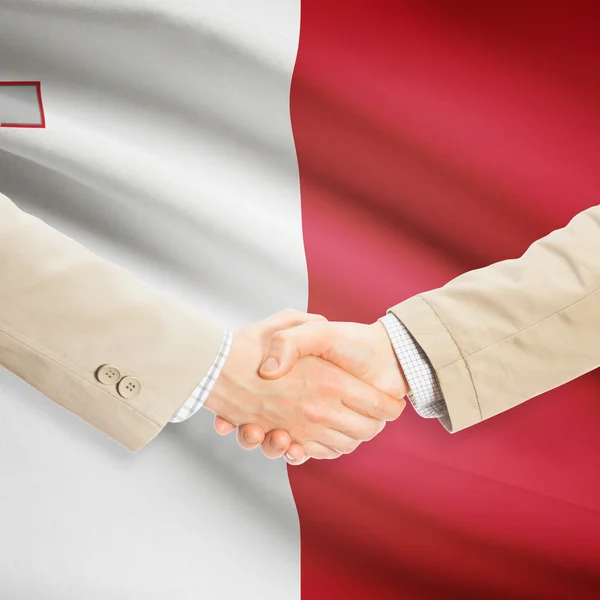 Businessmen handshake with flag on background - Malta — Stock Photo, Image