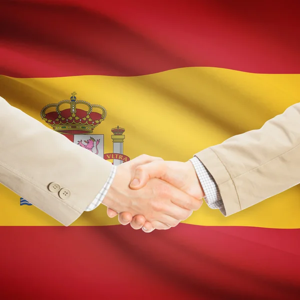 Businessmen handshake with flag on background - Spain — Stock Photo, Image