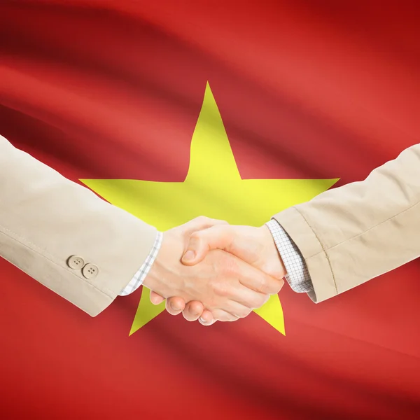 Businessmen handshake with flag on background - Vietnam — Stock Photo, Image