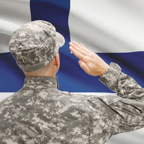 Soldier in hat facing national flag series - Finland — Stock Photo, Image