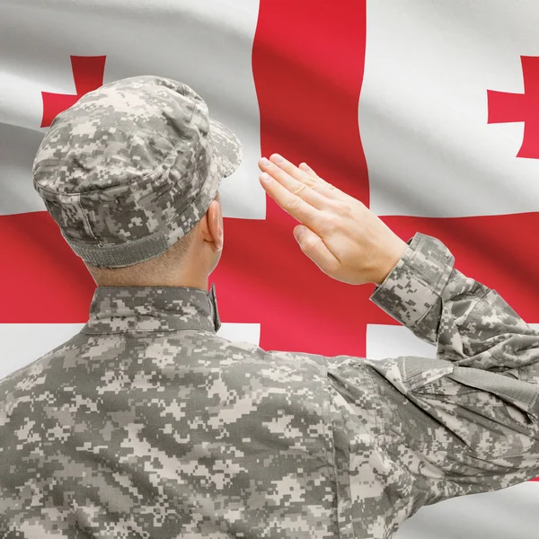 Soldier in hat facing national flag series - Georgia — Stock Photo, Image