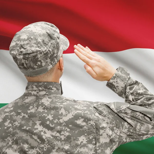 Soldier in hat facing national flag series - Hungary — Stock Photo, Image