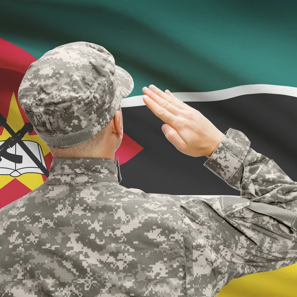 Soldier in hat facing national flag series - Mozambique — Stock Photo, Image