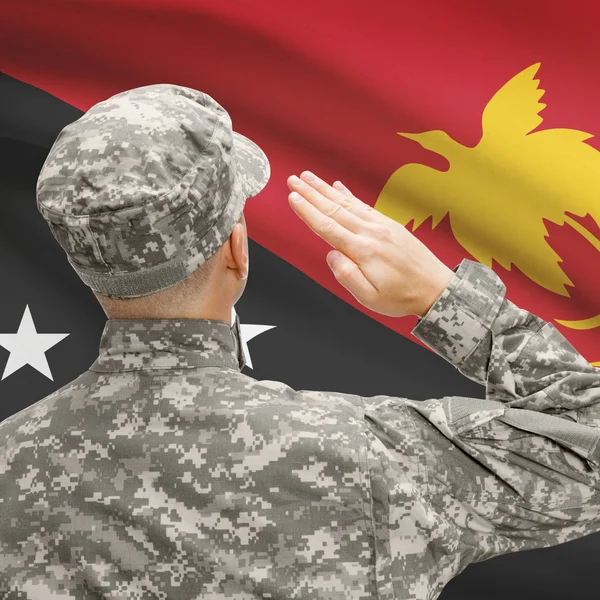 Soldier in hat facing national flag series - Papua New Guinea — Stock Photo, Image