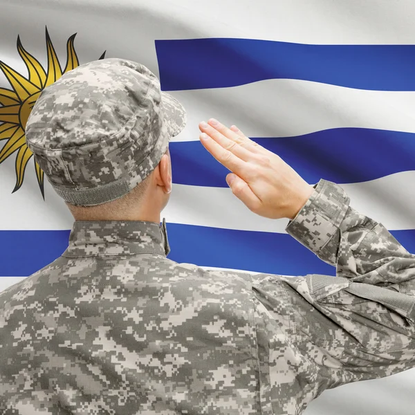 Soldier in hat facing national flag series - Uruguay — Stock Photo, Image