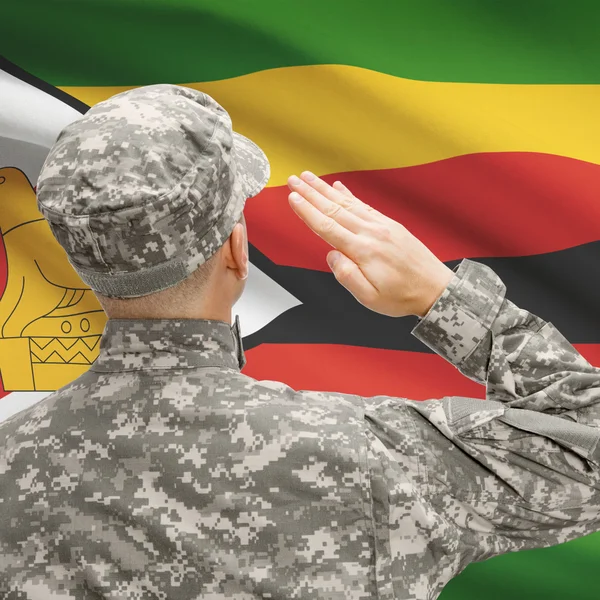 Soldier in hat facing national flag series - Zimbabwe — Stock Photo, Image