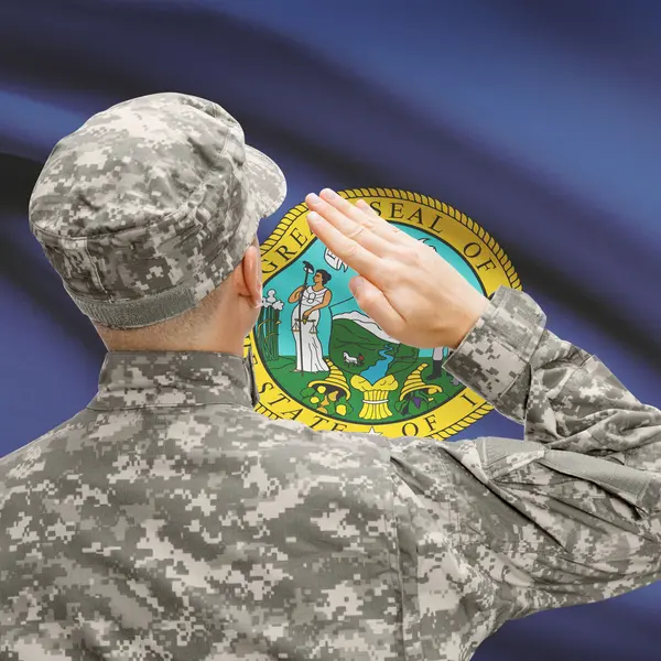 Soldier saluting to US state flag series - Idaho — Stock Photo, Image