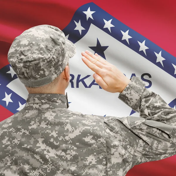 Soldier saluting to US state flag series - Arkansas — Stock Photo, Image