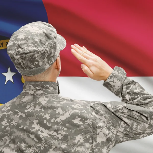 Soldier saluting to US state flag series - North Carolina — Stock Photo, Image