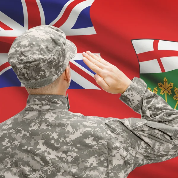 Soldier saluting to Canadial province flag series - Ontario — Stock Photo, Image