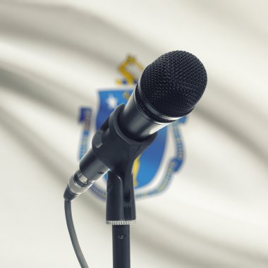 Microphone on stand with US state flag on background - Massachus