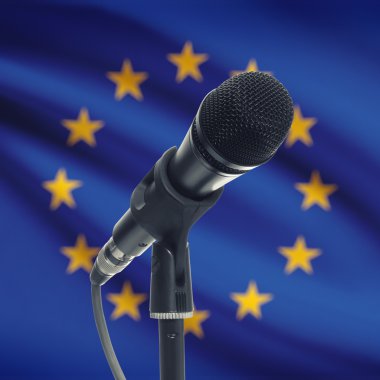 Microphone on stand with national flag on background - European 