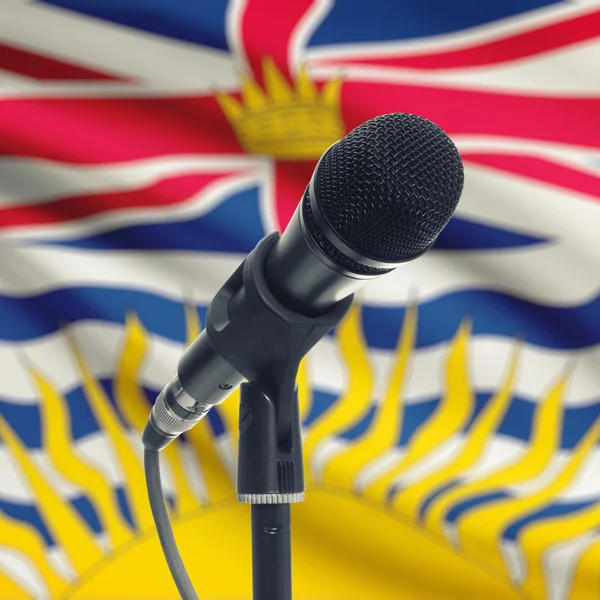 Microphone on stand with Canadian province flag on background - — Stock Photo, Image