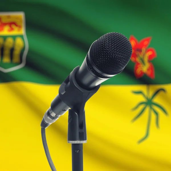 Microphone on stand with Canadian province flag on background - — 图库照片