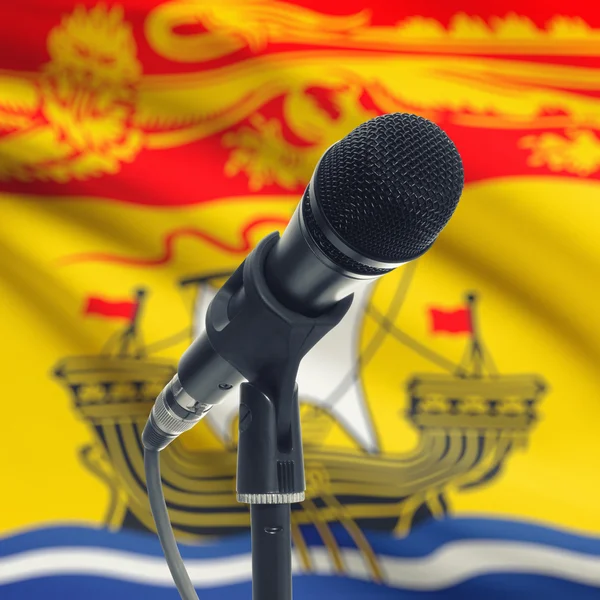 Microphone on stand with Canadian province flag on background - — Stockfoto