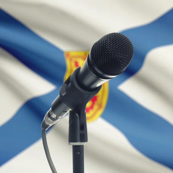 Microphone on stand with Canadian province flag on background - —  Fotos de Stock