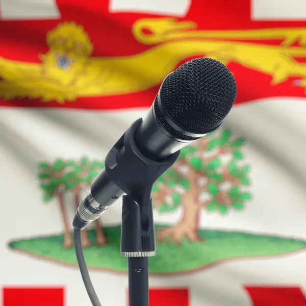 Microphone on stand with Canadian province flag on background - — Stock Photo, Image