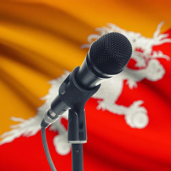 Microphone on stand with national flag on background - Bhutan — Stock Photo, Image