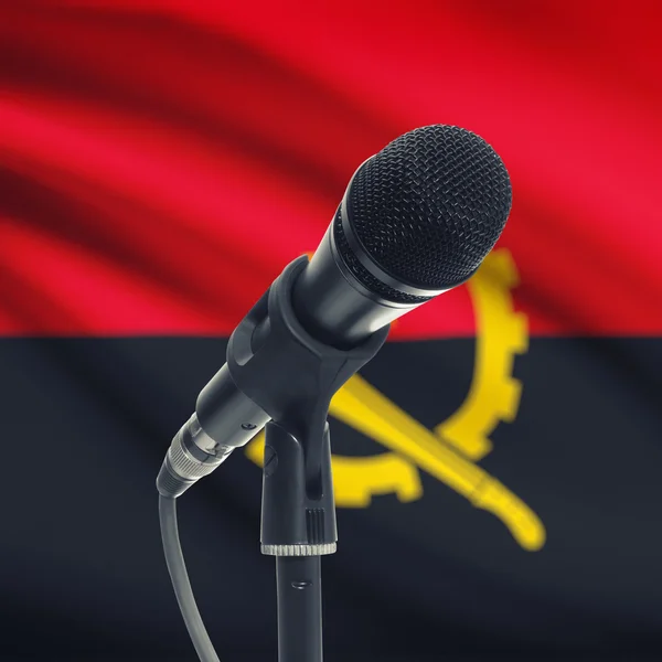 Мікрофон на стенді з національного прапора на фоні - Ангола — стокове фото