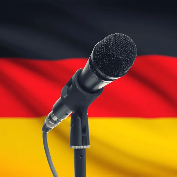 Microphone on stand with national flag on background - Germany — kuvapankkivalokuva