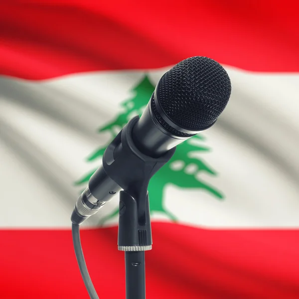 Microphone on stand with national flag on background - Lebanon — Stock Photo, Image