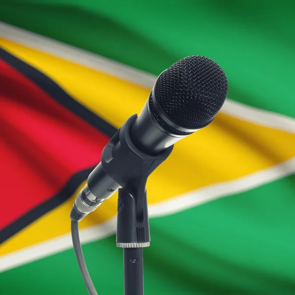 Microphone on stand with national flag on background - Guyana — Stock Photo, Image