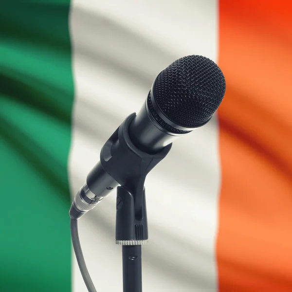 Microphone on stand with national flag on background - Ireland — Stock Photo, Image