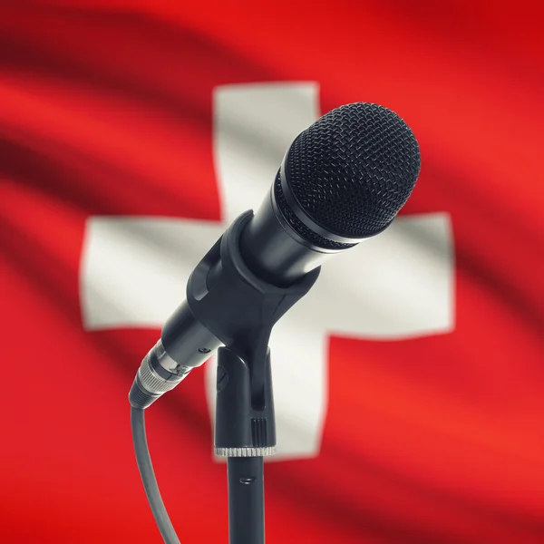 Microphone on stand with national flag on background - Switzerla — Stock Photo, Image
