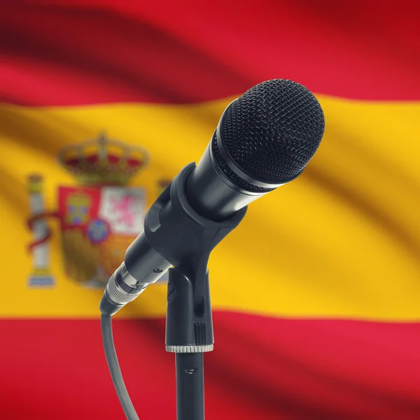 Microphone on stand with national flag on background - Spain — Stock Photo, Image
