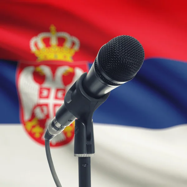 Microphone on stand with national flag on background - Serbia — Stock Photo, Image