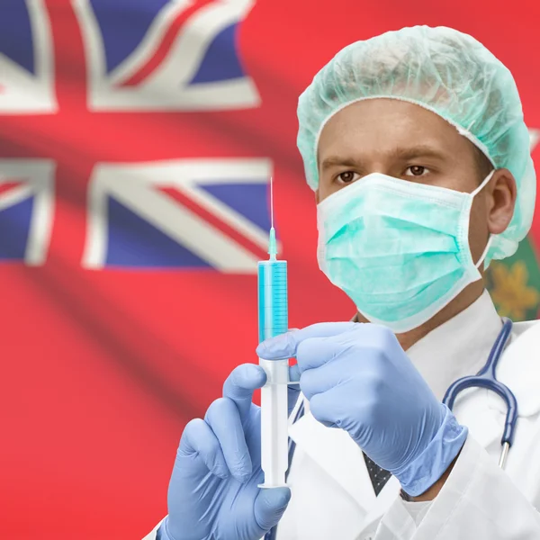 手とオンタリオ州カナダの州旗シリーズで注射器を持つ医師 — ストック写真