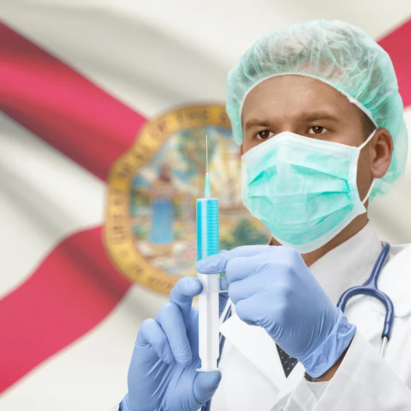 Arts met spuit in handen en ons Staten vlaggen serie - Florida — Stockfoto