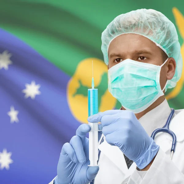 Médico com uma seringa nas mãos e bandeira série - Ilha Christmas — Fotografia de Stock