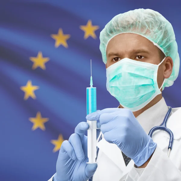 Médico com uma seringa nas mãos e série bandeira - União Europeia - UE — Fotografia de Stock