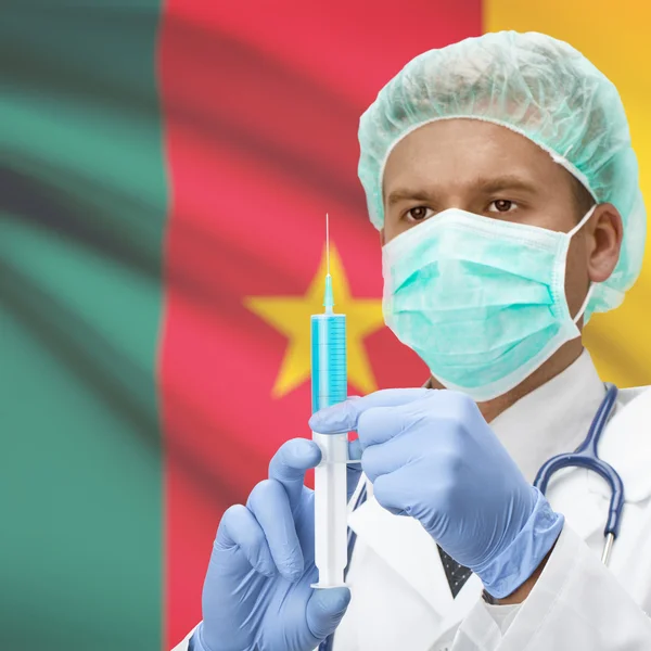 Доктор с шприц в руках и флаг серии - Камерун — стоковое фото